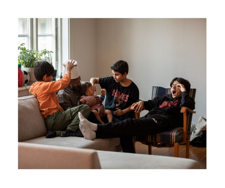 Postcard with children and father playing