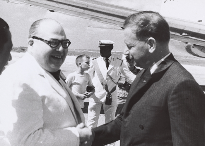 Dag Hammarskjöld shaking hands with someone.