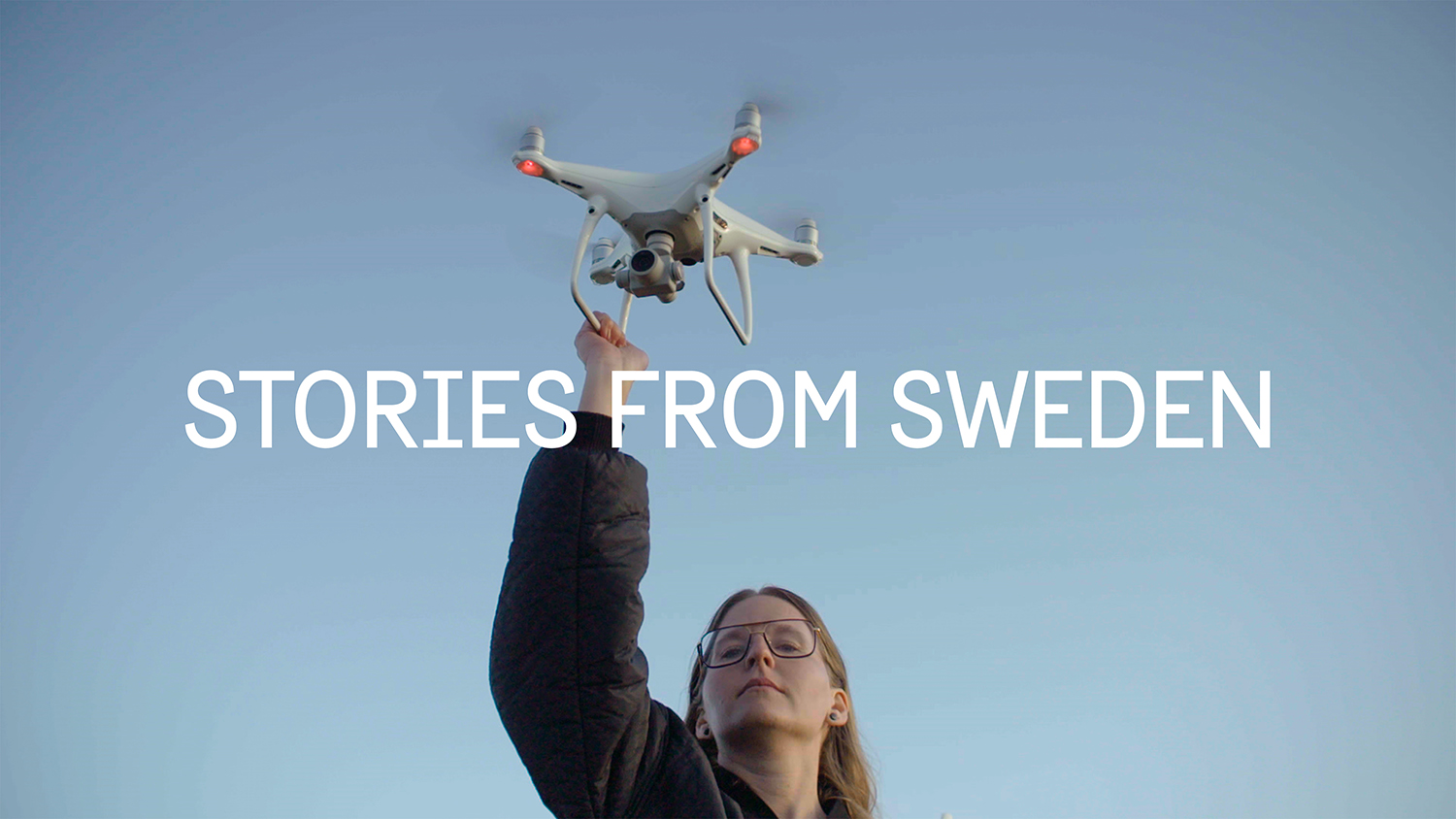 A woman releasing a drone into the air.