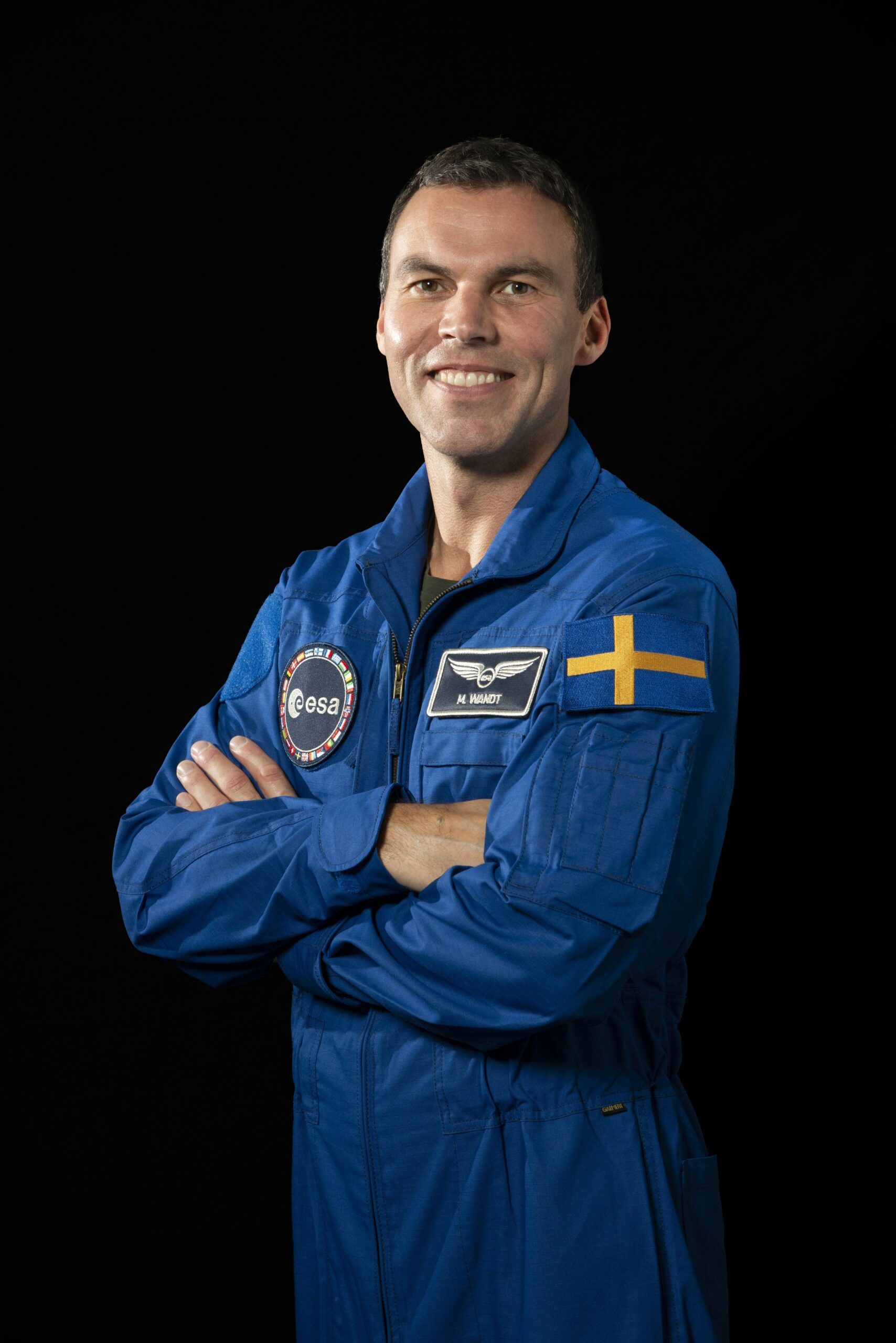 Marcus Wandt in a blue uniform with the Swedish flag on his arm.
