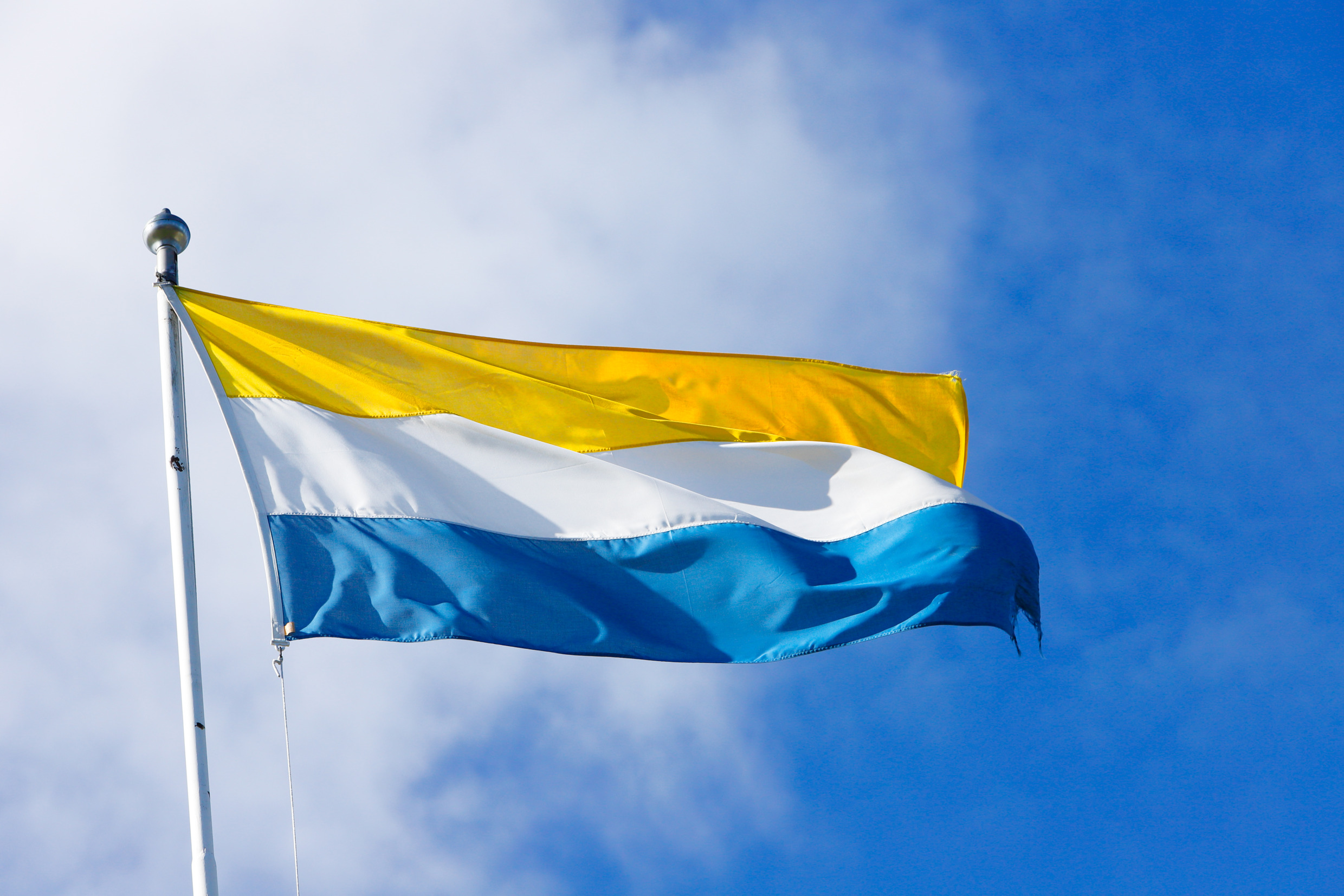 A yellow, white and blue flag.