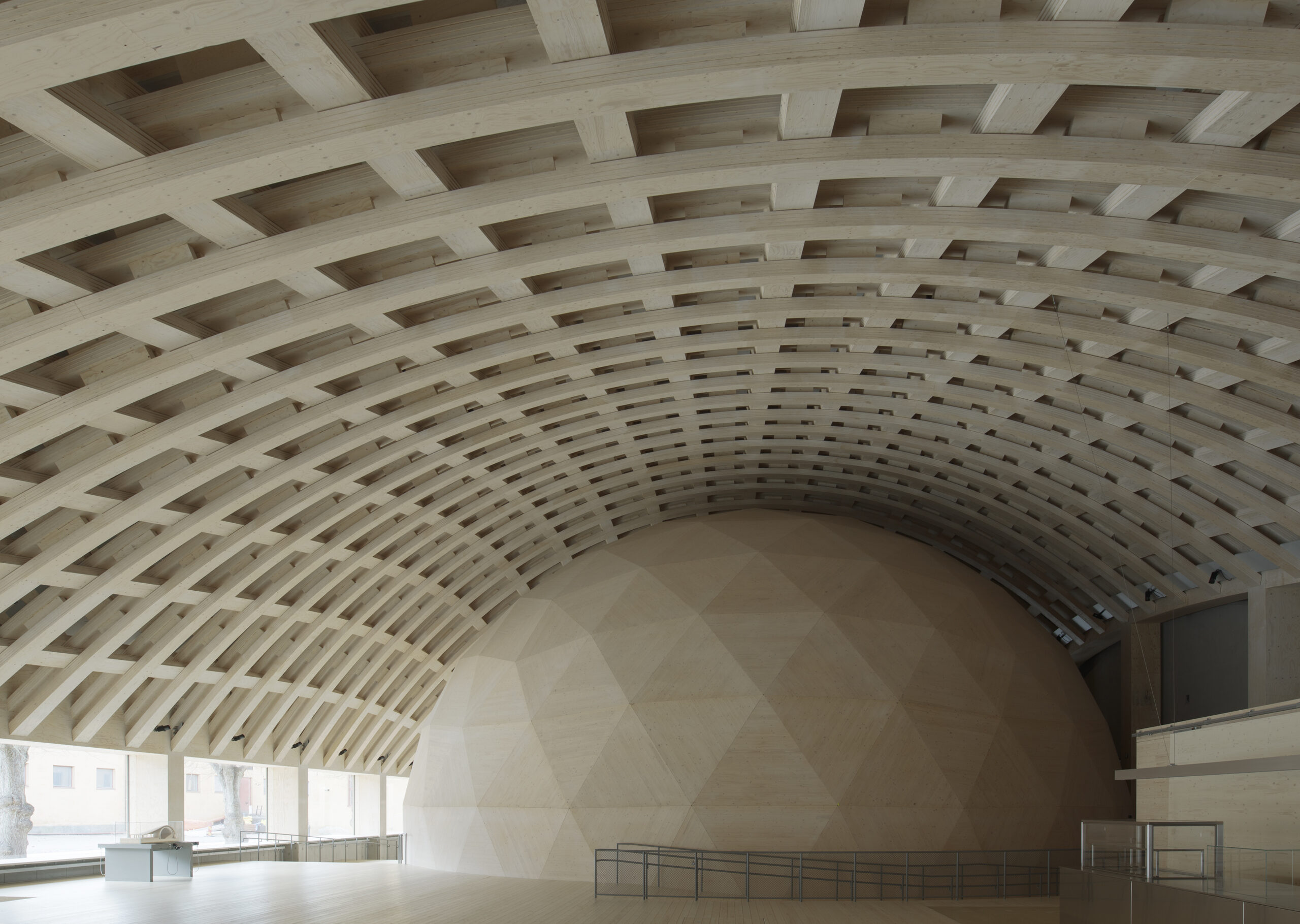 Inside of a wood dome building.